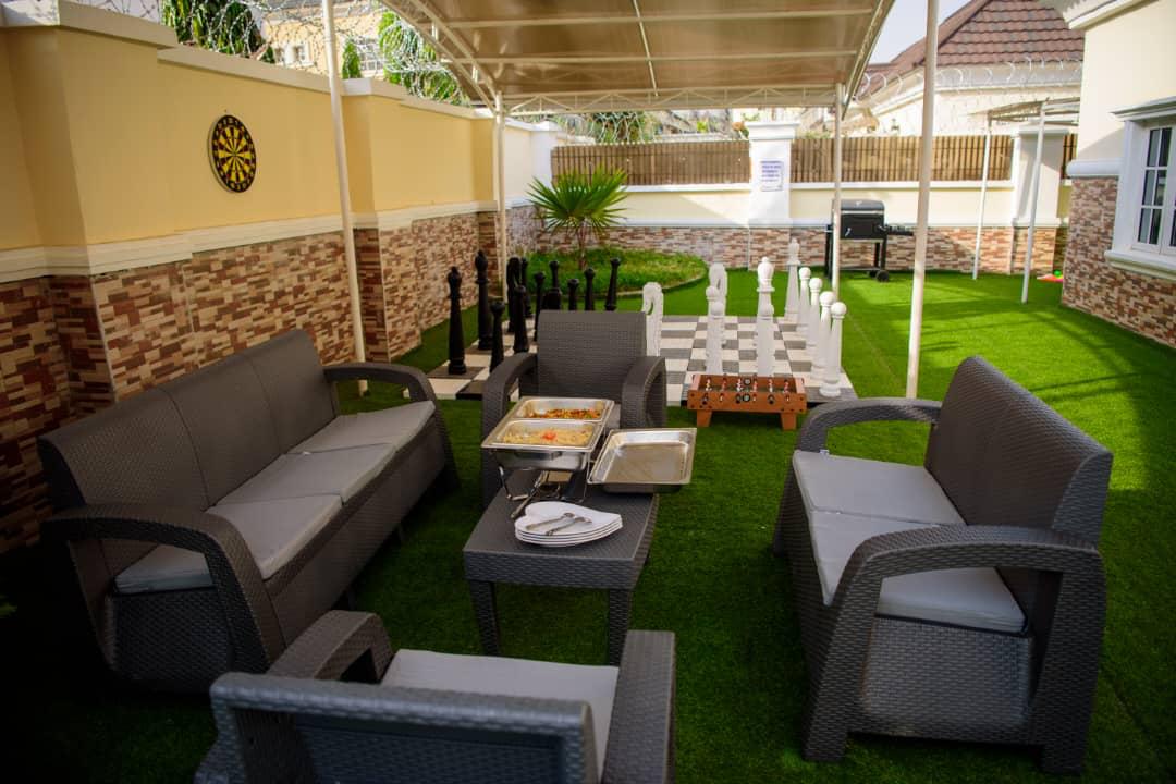 Shaded garden seating arranged on the lawn