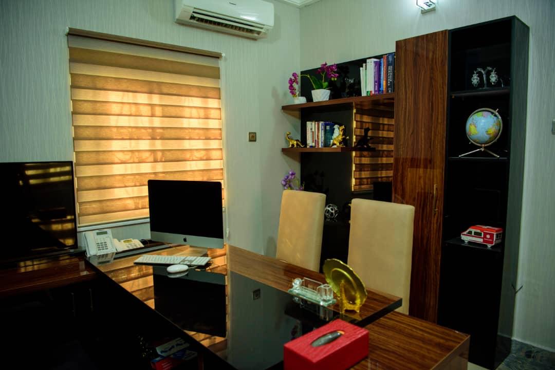 A therapy office with desk, bookshelves and natural light